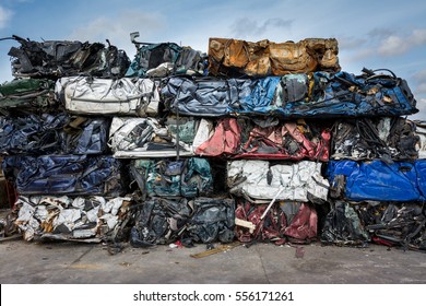 Cars in junkyard,  pressed and packed for recycling.  - Powered by Shutterstock