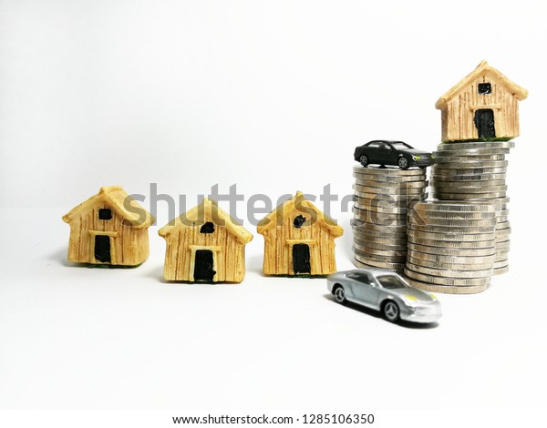 cars model, home model and coins stacks on white\
background . Finance\
concept
