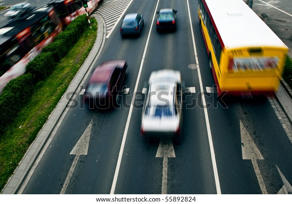 Cars in motion blur on a street of\
Wroclaw - city with the biggest traffic jams in\
Europe
