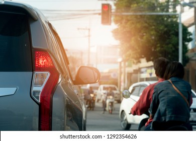 Cars and motorcycle on the road with light break at  crossroad by red light for stop with on the opposite side running past. Open light brake.