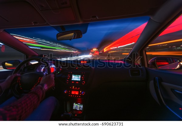 The car's movement at night with a kind of
speed from the inside, a brilliant road with lights with a car at
high speed. Car dashboard