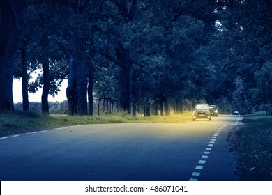 Cars moving on the road at night in summer