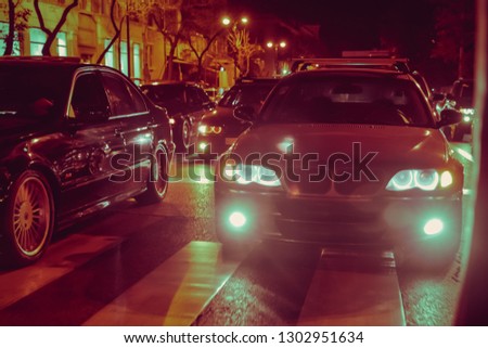 Cars in the night traffic jam . Looking behind the cars.Cars are red, yellow night light. Traffic jams in the city with row of cars on the road at night and bokeh lights in Baku with selective focus