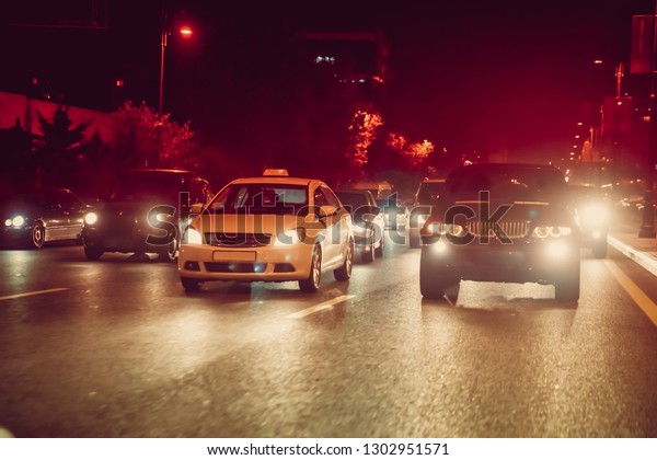 Cars in the night traffic jam . Looking behind the
cars.Cars are red, yellow night light. Traffic jams in the city
with row of cars on the road at night and bokeh lights in Baku with
selective focus