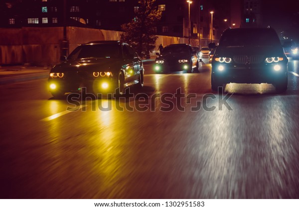 Cars in the night traffic jam . Looking behind the\
cars.Cars are red, yellow night light. Traffic jams in the city\
with row of cars on the road at night and bokeh lights in Baku with\
selective focus