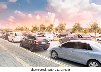 Cars On Asphalt Street Near Pavement With Sunset Sky Background. Transportation Technology, Traffic Jam, Car Parking, Rush Hour, Parked On Street
