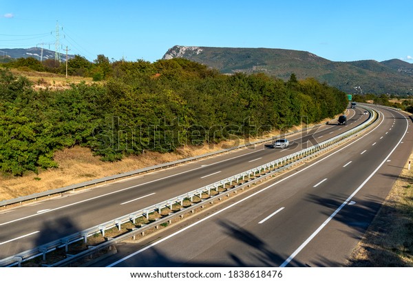 cars on the highway\
through countryside 