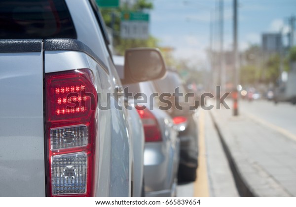 Cars on\
the road adjacent to the traffic lights\
stop.