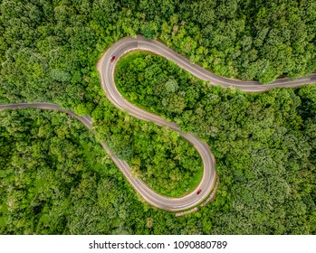 Cars on road. Extrem winding road in the middle of the forest, Carpathian Mountains