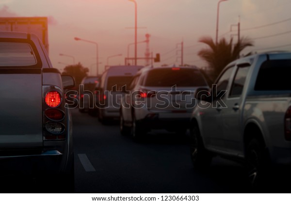 Cars on the road\
heading towards the goal of the trip, tourism by car, Break in\
traffic junction at\
evening.