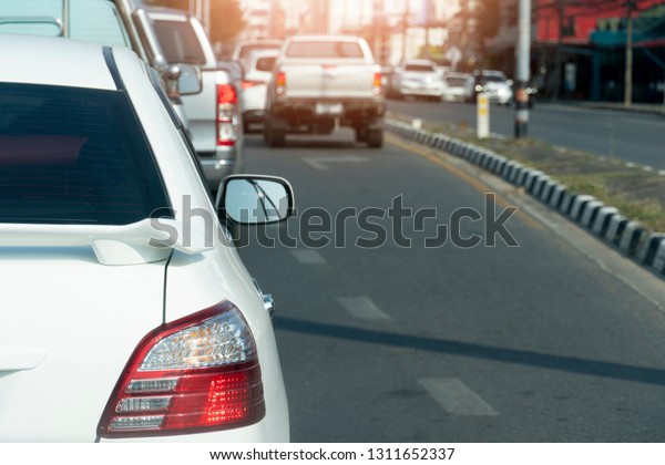 Cars on the road heading\
towards the goal of the trip, tourism by white car, Break in\
traffic junction.