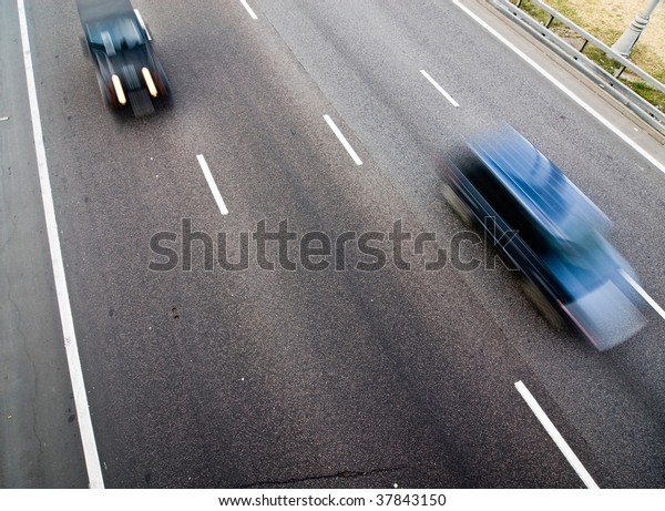 Cars on a road with\
motion blur effect