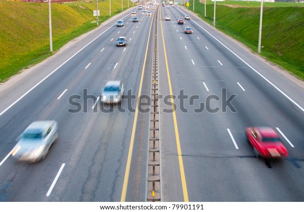 Cars on a road with\
motion blurred effect