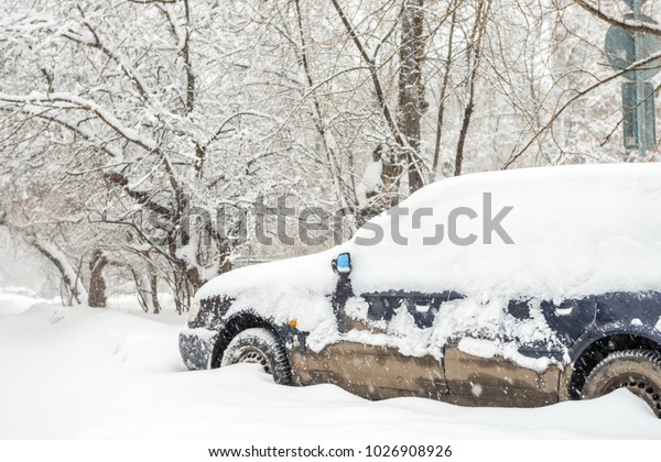 Cars on the street in the\
snow