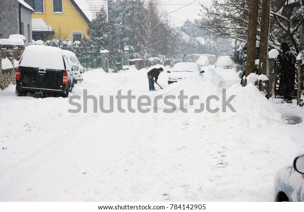 Cars on street in snow\
storm