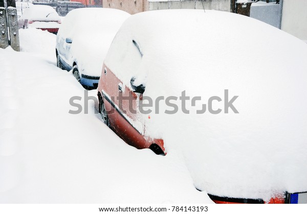 Cars on street in snow\
storm
