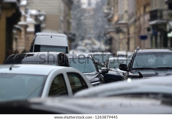 Cars on the street stuck in the traffic jam,\
road collapse in the city\
close-up