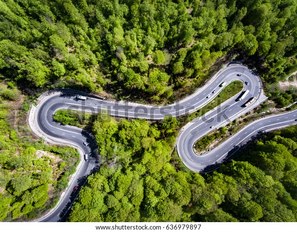 Cars on winding road trough the forest,\
Transfagarasan, Romania