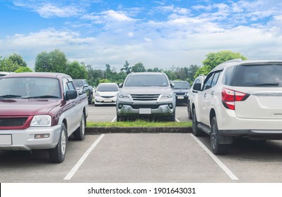 Cars Parked In Asphalt Parking Lot. Trees, White Cloud Blue Sky Background, Empty Space For Car Parking. Outdoor Parking Lot In A Park
