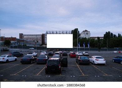 Cars parked in front of drive-in cinema screen, top view. Free time, leisure and entertainment concept