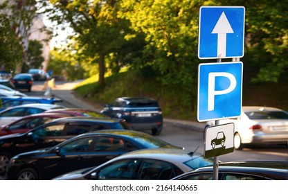 Cars Parked On Parking Lot At Downtown, Parking Problems Not Enough Free Space. Crowded Public Parking Lot On Narrow Street. Rows Of Cars Parked On Roadside, Parking Sign. 