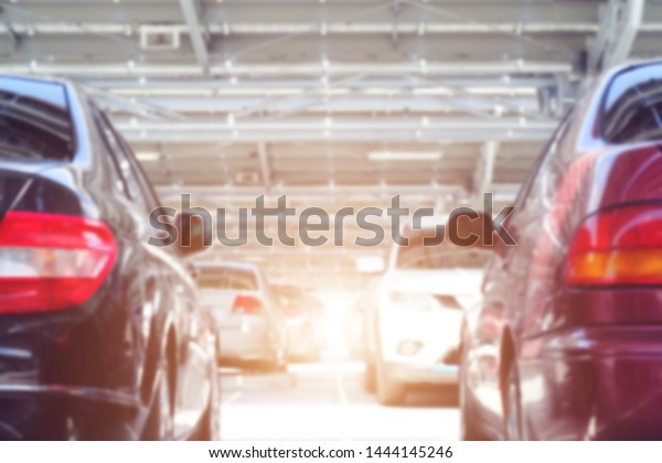 Cars parked in outdoor parking lot at a park,\
White car in the lodge,\
garage.