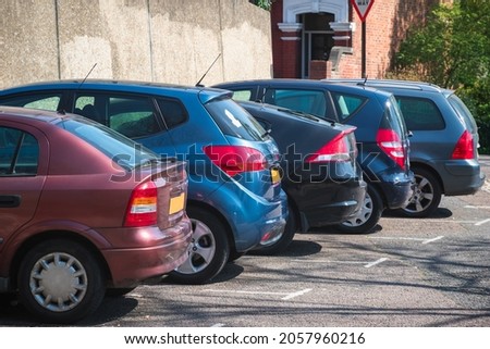 Cars parked in row on outdoor parking in London