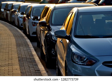 Cars parked in a row parallel to the curb
