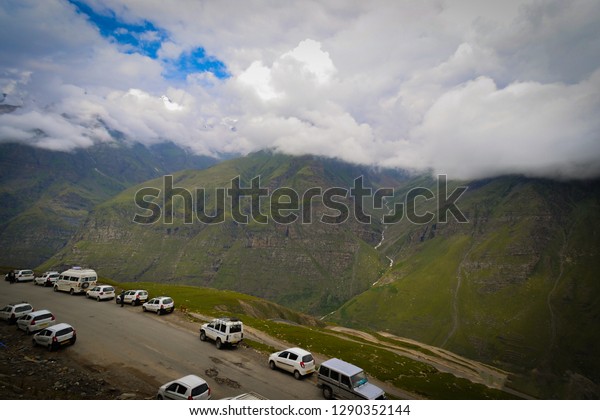 Cars parked a tourist\
spot in mountains 
