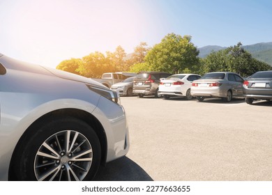 Cars parking in asphalt parking lot in a row with blue sky background. Vehicle transportation trip inventory merchandise - Shutterstock ID 2277663655