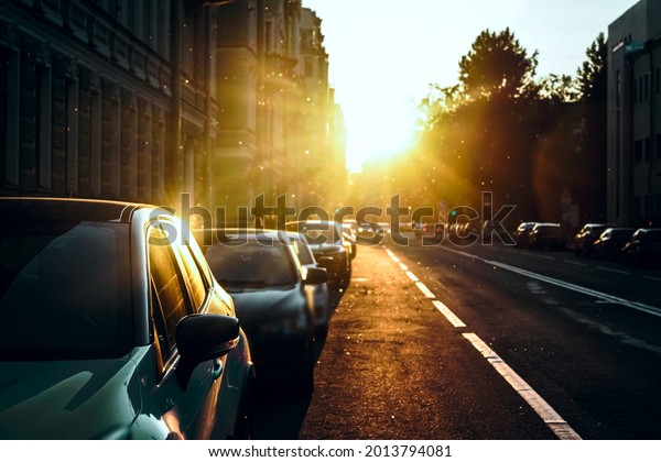 Cars parking on the\
road in city in early morning. View to the automobiles, parked in\
the town\
