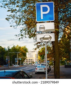 Cars In Parking Zone At Roadside In The City. Parking Lot Sign, One Free Parking Space, Cars In Parked Zone, Evening Car Park