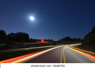 Cars Pass On A Country Road At Night