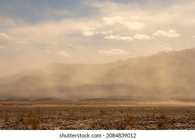 Cars Pass Through A Sandstorm at Devils Cornfield In Death Valley - Shutterstock ID 2084839012