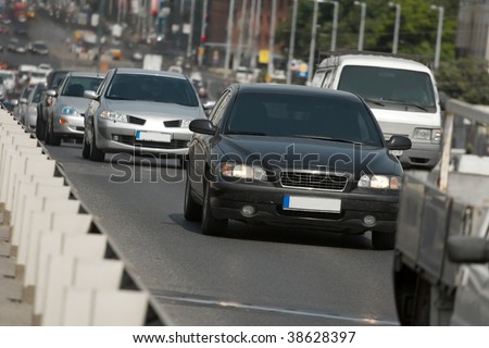 Cars passing by on a busy urban road