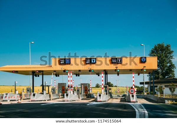 Cars Passing\
Through The Automatic Point Of Payment On A Toll Road. Point Of\
Toll Highway, Toll Station. Highway Toll Plaza Or Turnpike Or\
Charging Point, Entrance On\
Motorway.