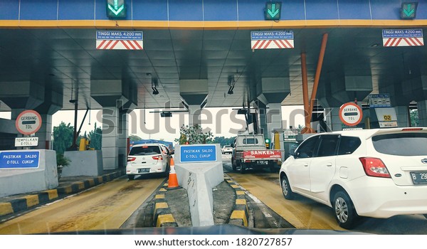 Cars passing through the toll gate\
at Tol Cipularang West Java, Indonesia. August\
2020
