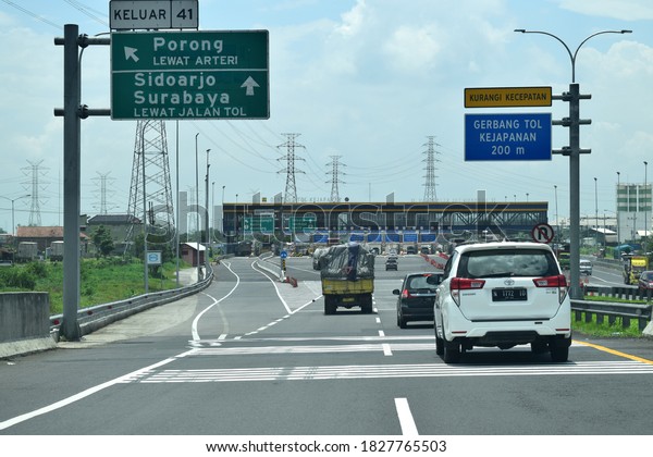 Cars are queuing at the exit of the\
Kejapanan toll road, Sidoarjo, which is the entrance and exit to\
the Trans Java toll road in Indonesia on March 2,\
2020