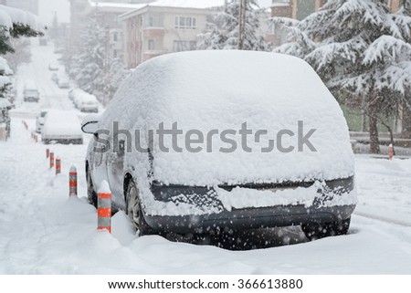 Cars and roads covered with snow