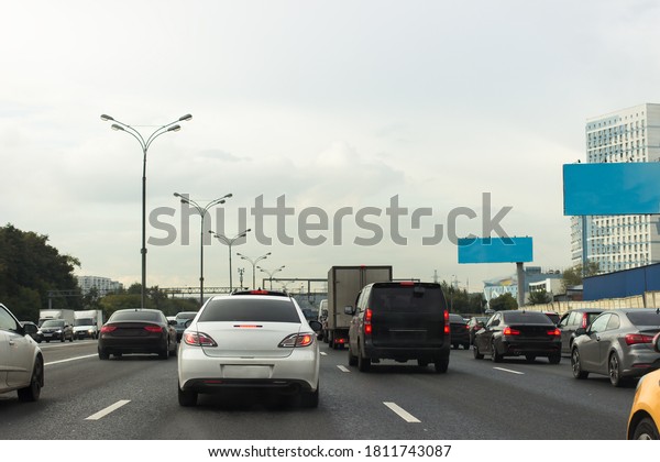 Cars rush hours city street. Cars on highway in\
traffic jam on road.