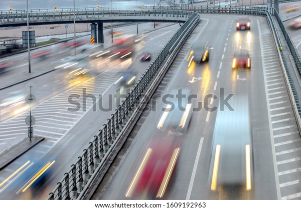 cars rush at speed along the highway of intentional\
motion blur