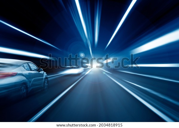Cars rush through the tunnel in the beams of\
searchlights. Motion\
effect.