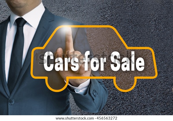 cars for sale auto touchscreen is operated by\
businessman concept.