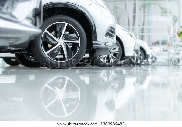 Cars For Sale, Automotive Industry, Cars\
Dealership Parking Lot. Rows of Brand New Vehicles Awaiting New\
Owners, on the epoxy floor in new car\
service