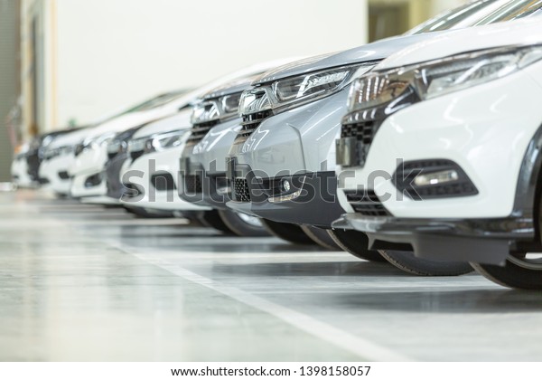 Cars For Sale, Automotive Industry, Cars\
Dealership Parking Lot. Rows of Brand New Vehicles Awaiting New\
Owners, on the epoxy floor in new car\
service