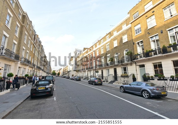 Cars are seen parked on a\
beautiful residential street in the borough of Westminster on June\
16, 2015 in London, UK. The British capital is a popular travel\
destination.