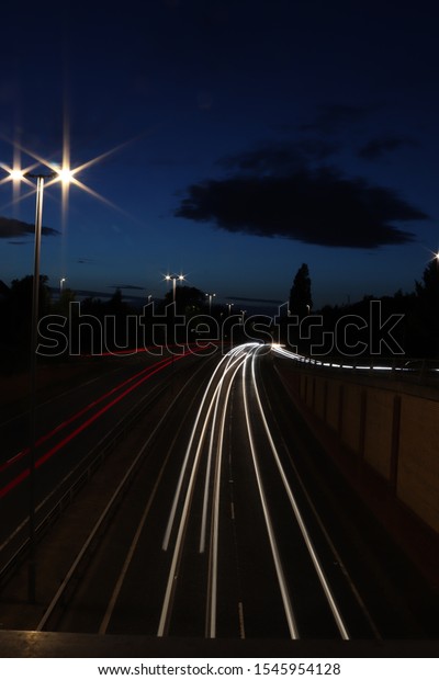 Cars showing streaks\
of light in evening