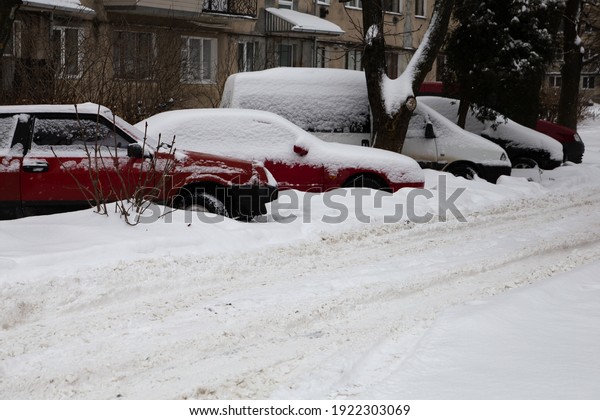 Cars in the snow in the city. There is a lot of\
snow around.
