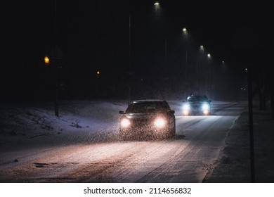 Cars in a snowstorm at night on the road in winter. Traffic in winter. Defocused - Powered by Shutterstock