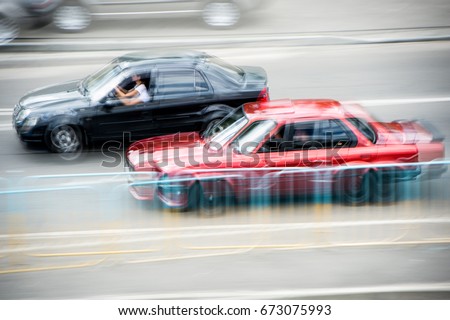 Cars at speed. Street racing. Blurred cars at speed.